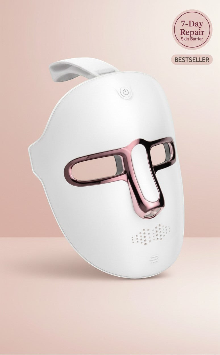 The Glow Lab 7-color LED light therapy facial mask in white with rose gold accents for home skin rejuvenation.