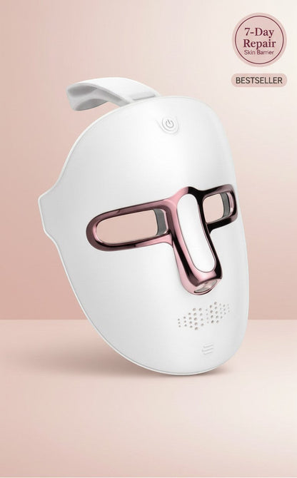 The Glow Lab 7-color LED light therapy facial mask in white with rose gold accents for home skin rejuvenation.