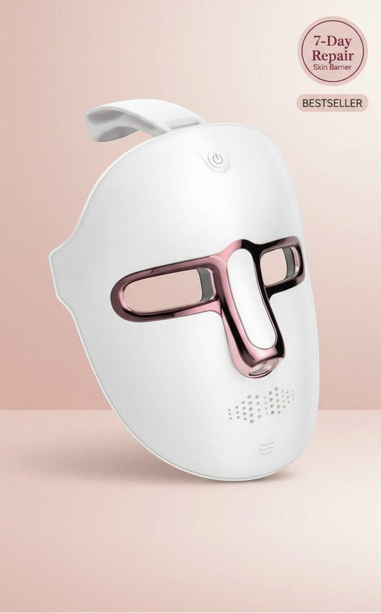 The Glow Lab 7-color LED light therapy facial mask in white with rose gold accents for home skin rejuvenation.